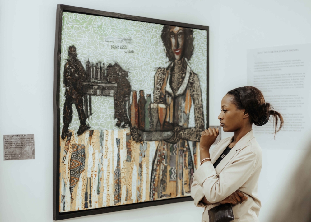 A visitor looks at one of different artworks that are diplayed at the exhibition