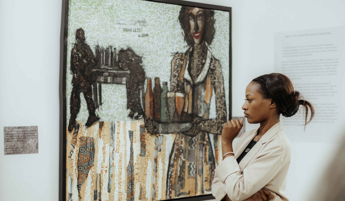 A visitor looks at one of different artworks that are diplayed at the exhibition