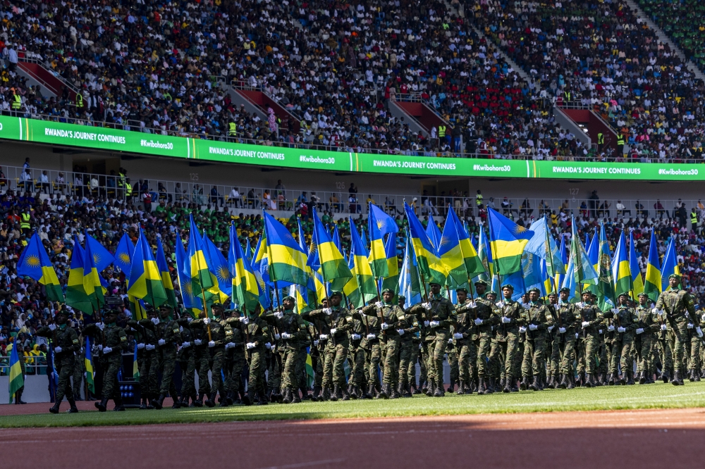 Members of the Rwanda Defence Force (RDF) parade with the national and RDF flags at the 30th Liberation Day anniversary ceremony at Amahoro Stadium on July 4, 2024. Photo by Olivier Mugwiza for The New Times