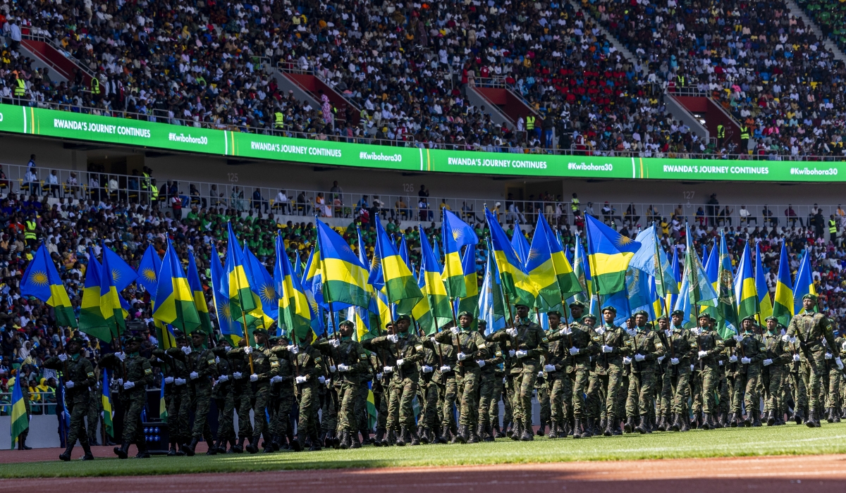 Members of the Rwanda Defence Force (RDF) parade with the national and RDF flags at the 30th Liberation Day anniversary ceremony at Amahoro Stadium on July 4, 2024. Photo by Olivier Mugwiza for The New Times