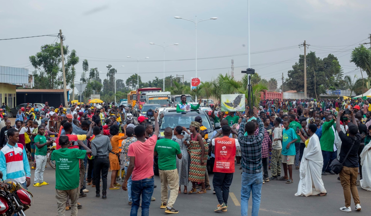 Frank Habineza, the Democratic Green Party of Rwanda flag bearer greets residents of Gahanga during a campaign rally in  Kicukiro district on June 8. Courtesy