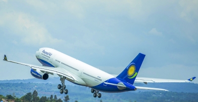A RwandAir plane takes off at Kigali International Airport. Founded in December 2002, the national carrier now operates 13 planes including three Airbus A330s, seven Boeing 737s, two Bombardier CRJ900s, and two De Havilland Canada Dash 8-Q400s. The governing Rwanda Patriotic Front promises to significantly expand the national aviation industry, doubling the number of passengers transported by RwandAir and enhancing cargo transport in the next five years. Photo by Sam Ngendahimana