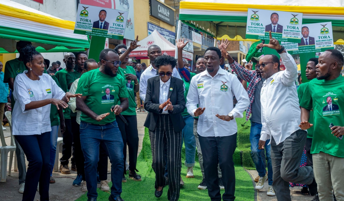 Frank Habineza, the chairman of the Democratic Green Party of Rwanda and party members dance during a campaign event in Muhanga District on Tuesday, July 9. Courtesy