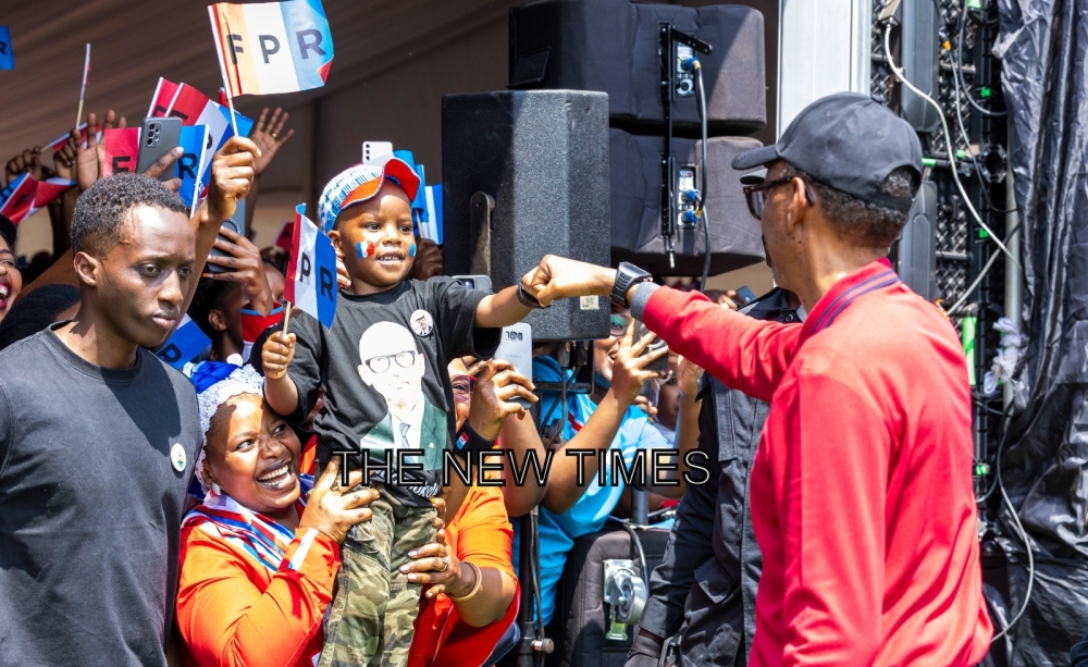 RPF-Inkotanyi presidential candidate Paul Kagame gives a fist bump to a young boy upon arrival at Nemba campaign site in Gakenke District, on Thursday, July 11. All photos by Olivier Mugwiza