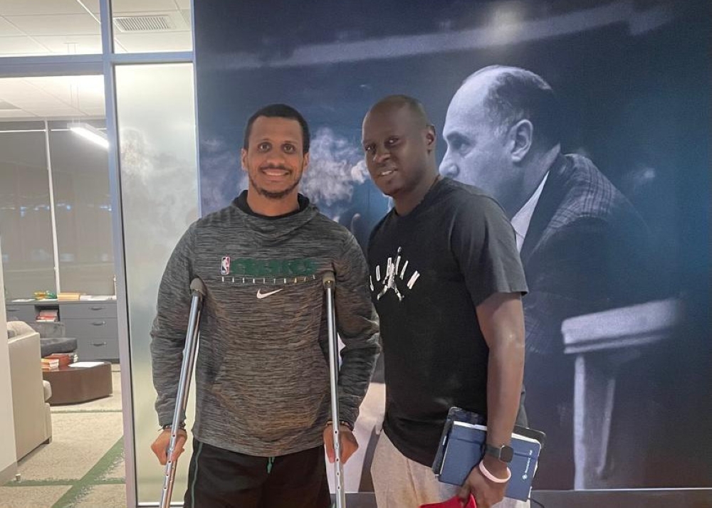 Mugisha (left) poses for a picture with Joe Mazulla, Celtics&#039; head coach on the sidelines of the preparations for the summer league.