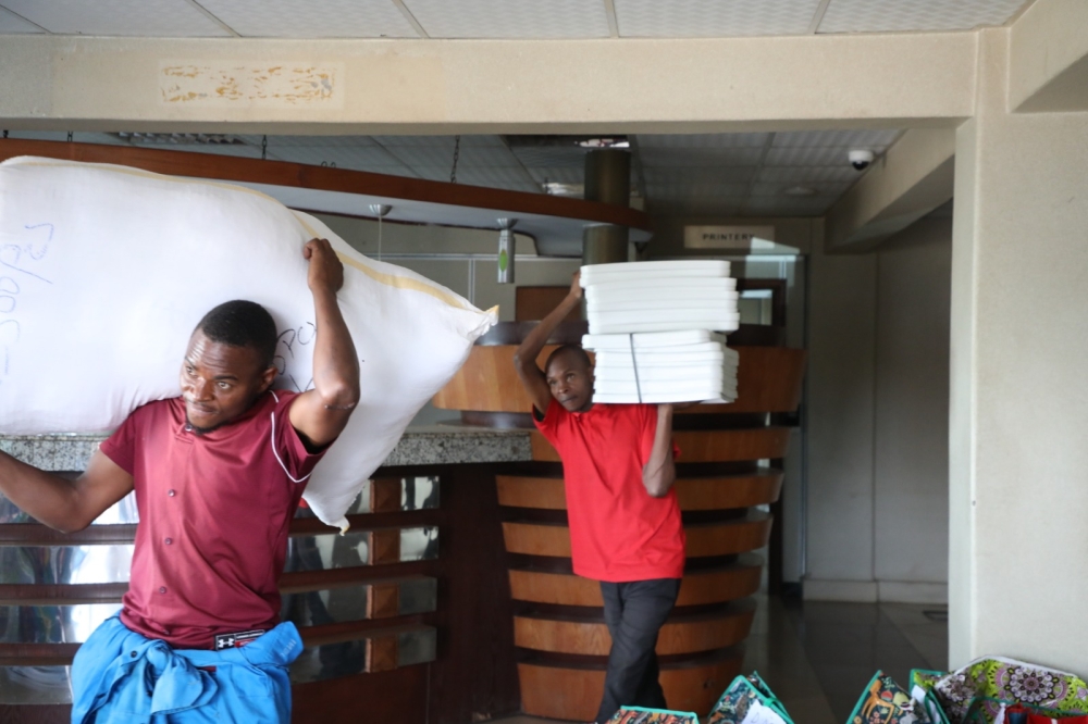 Workers carry voting materials that are being dispatched to polling centres countrywide, on Friday, July 12. Voting materials including ballot papers, ballot boxes, voter lists, t-shirts, and electoral ink. Photos by Emmanuel Dushimimana