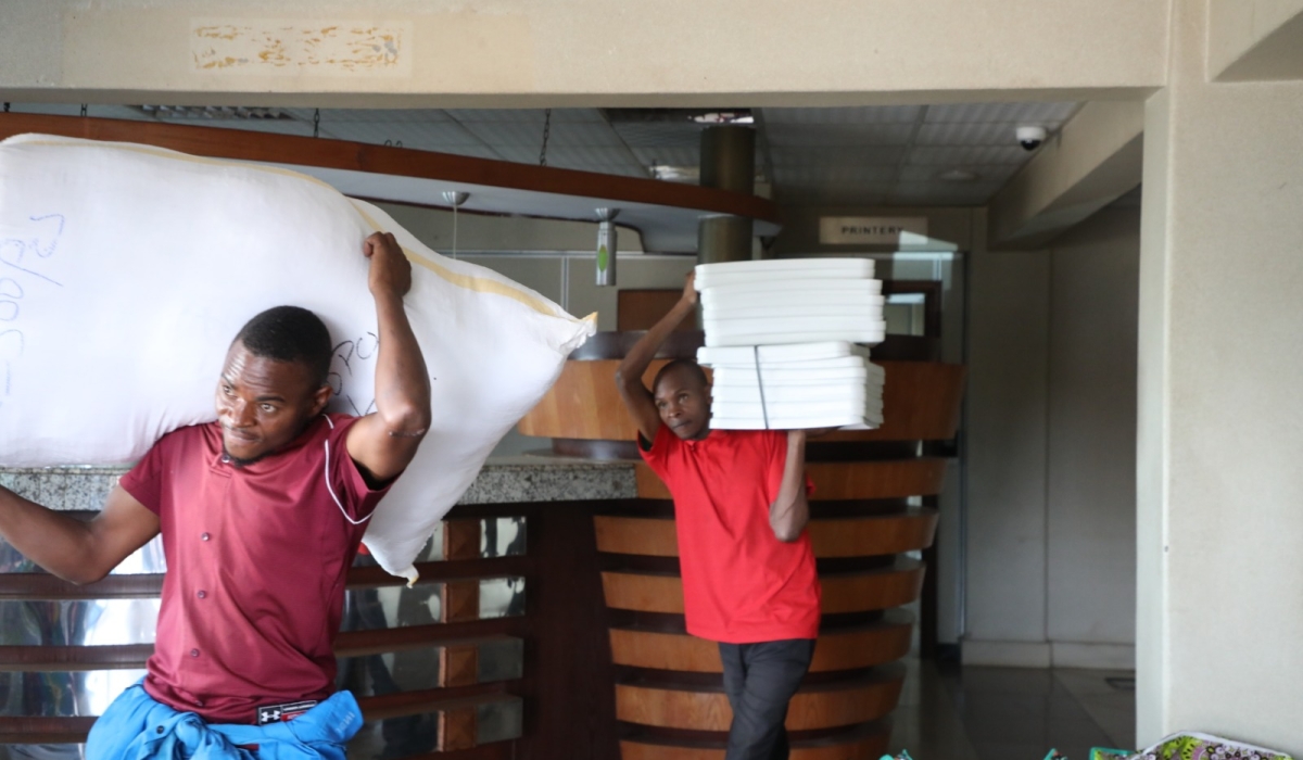 Workers carry voting materials that are being dispatched to polling centres countrywide, on Friday, July 12. Voting materials including ballot papers, ballot boxes, voter lists, t-shirts, and electoral ink. Photos by Emmanuel Dushimimana