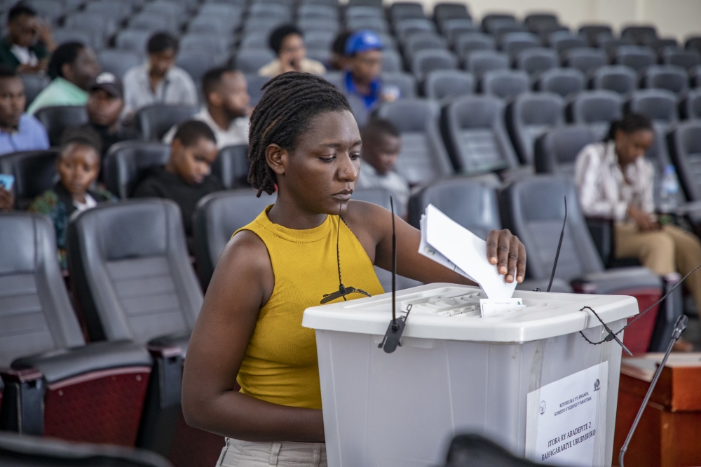 A voter from electoral college of youth representatives  casts her vote for two parliamentary representatives in the Chamber of Deputies in Gasabo District. Emmanuel Dushimimana