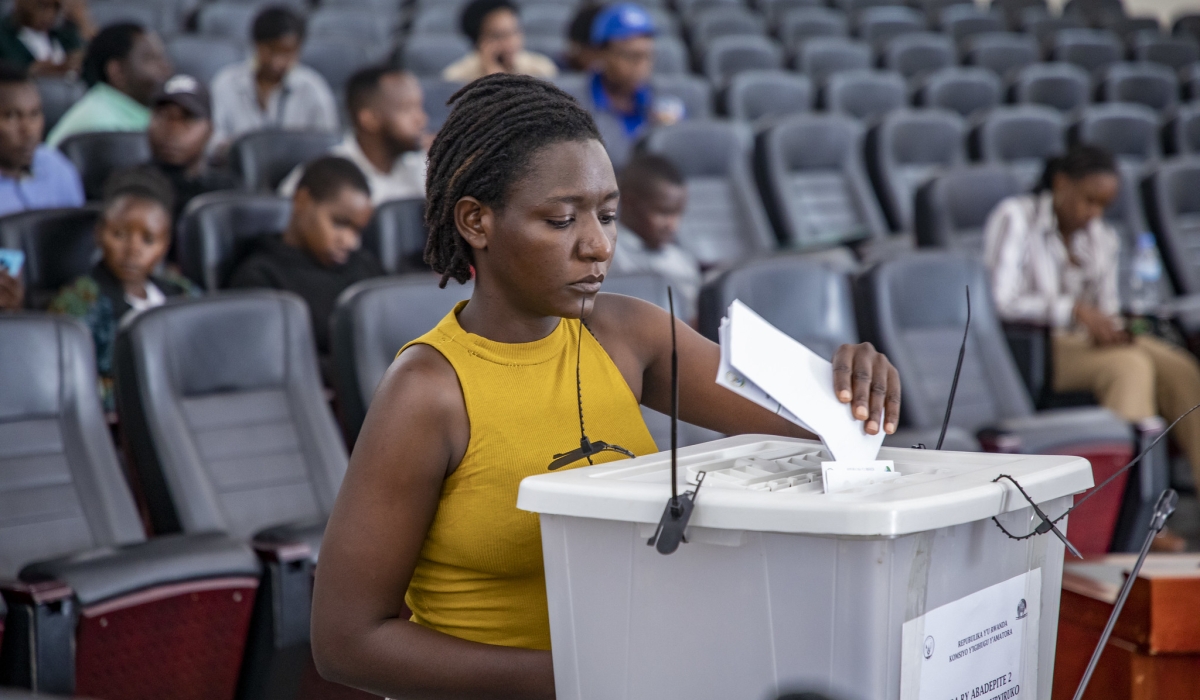 A voter from electoral college of youth representatives  casts her vote for two parliamentary representatives in the Chamber of Deputies in Gasabo District. Emmanuel Dushimimana