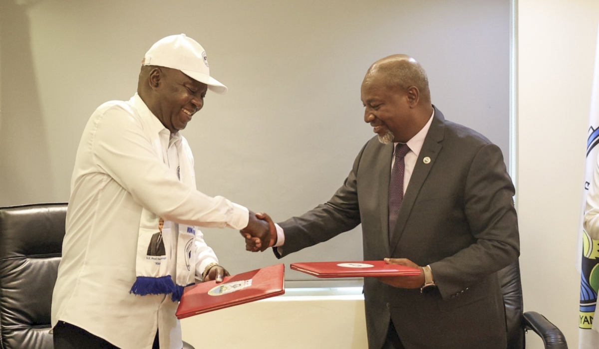 The Central African Republic’s Mouvement Cœurs Unis National Executive Secretary Simplice Sarandji and RPF-Inkotanyi Secretary General Wellars Gasamagera exchange documents after signing a party-to-party bilateral agreement, in Kigali, on Wednesday, July 17. Courtesy