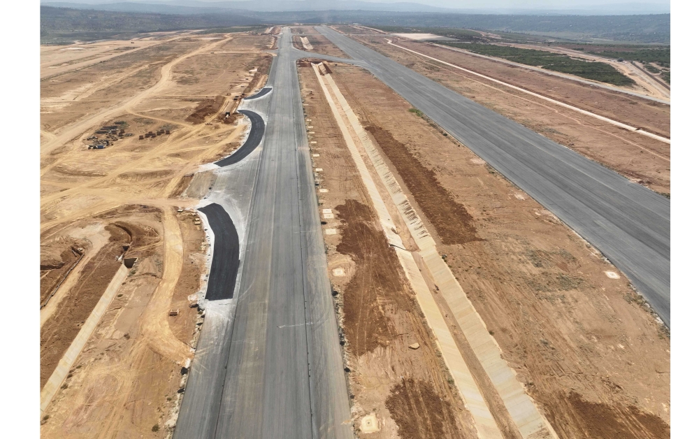 Runway and taxiway with drainage channel at the new airport under construction in Bugesera District. Once completed, the airport will have a 130,000-square-meter main terminal structure capable of handling 8 million passengers per year, and this is expected to increase to more than 14 million in the future. Photos: Courtesy.