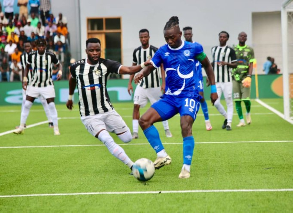 APR&#039;s Mugisha vies for the ball with an Al Hilal player during the match.