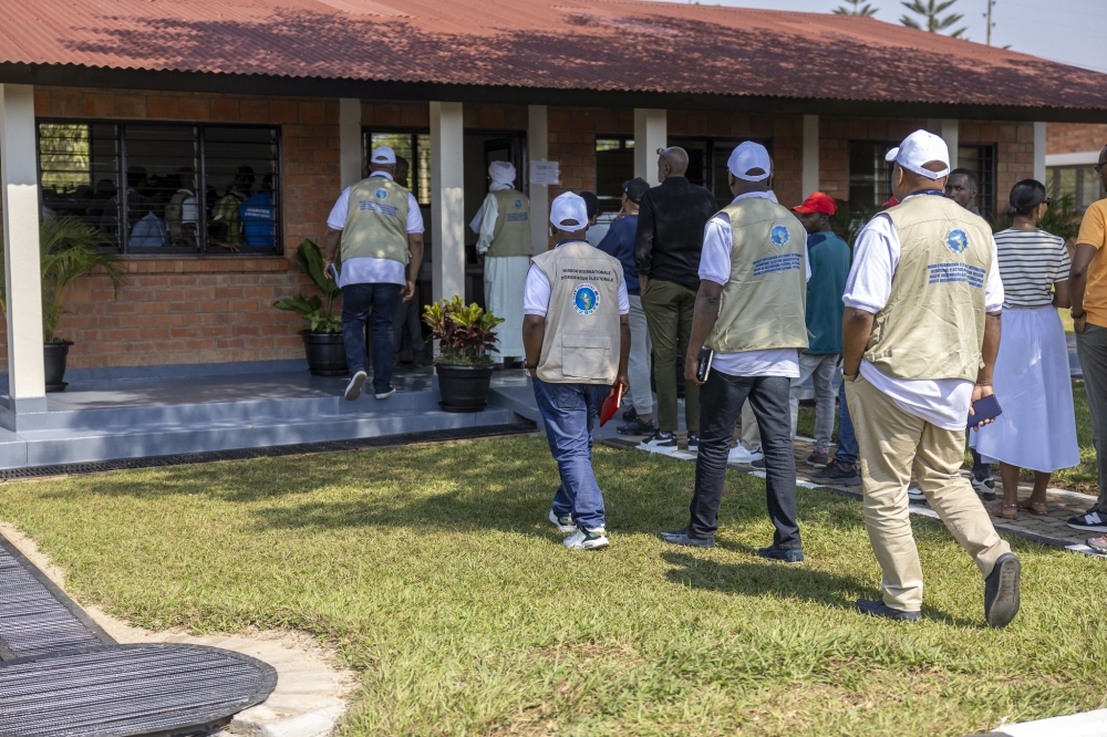 Observers enter a polling room to follow the conduct of elections on July 15. Photo  by Olivier Mugwiza