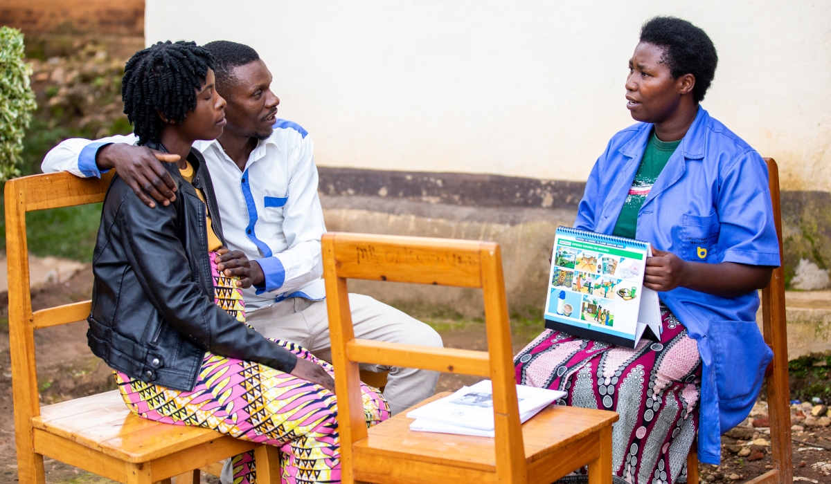 A community health worker interacts with a pregnant woman with her husband at Mubuga Hospital in Karongi District on December 9, 2022. Photo by Olivier Mugwiza