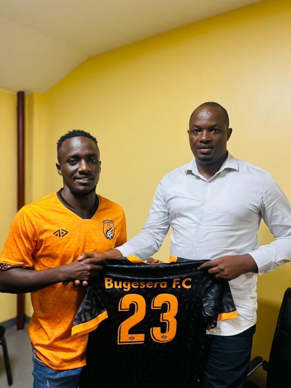 Yannick Bizimana (Left) poses for a picture during the signing ceremony.