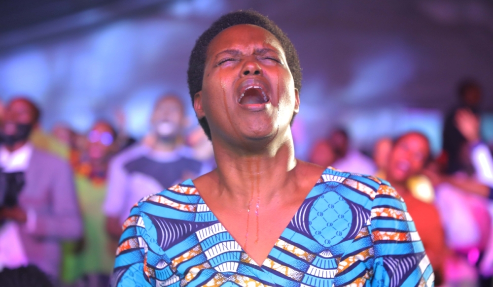 A christian sings for God during a praise and worship session in a past gospel concert in Kigali. File