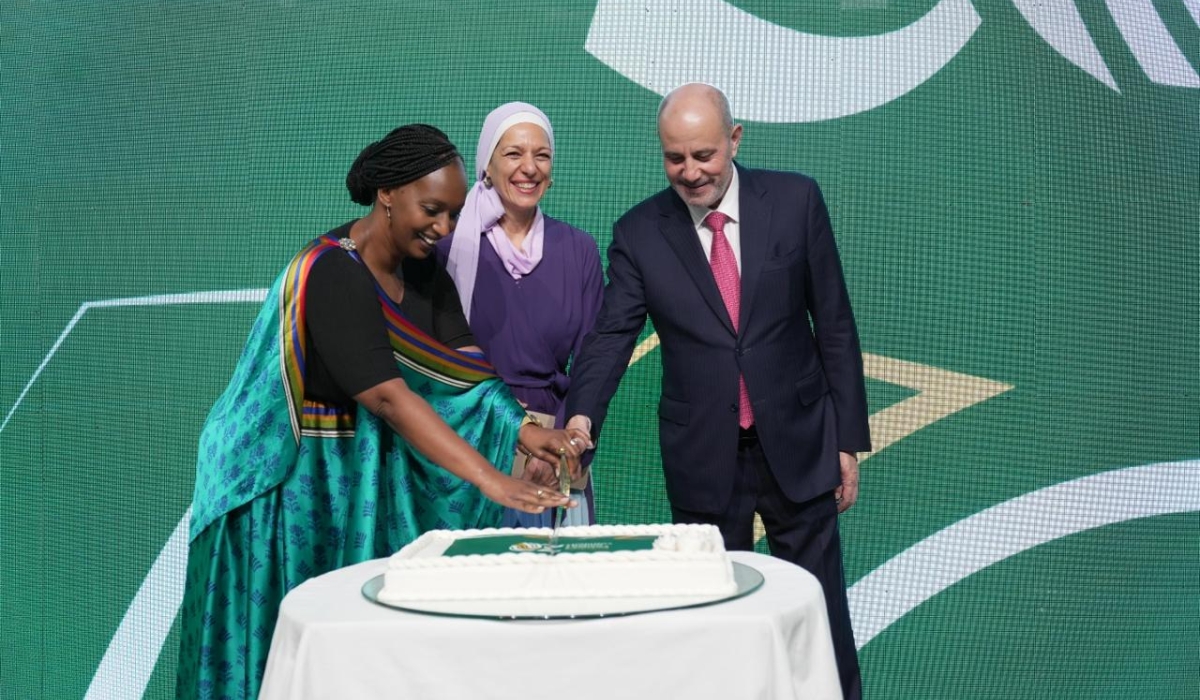 Ambassador Urujeni Bakuramutsa, Princess Basma bint Talal, and Yousef Al - Shamali, Minister of Industry, Trade and Supply cut a cake during the celebration.