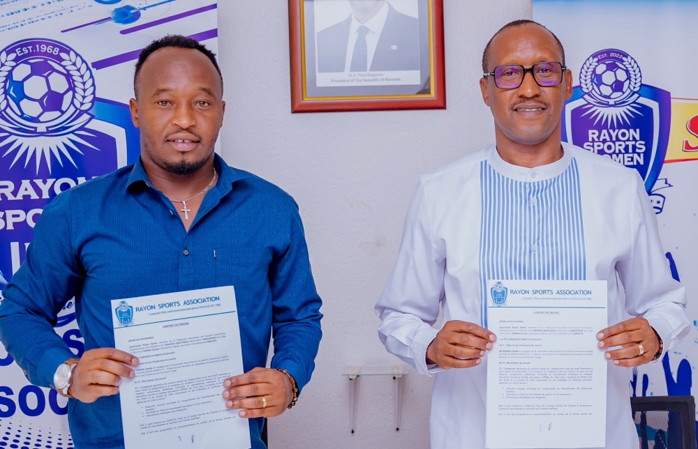 Rayon Sports Women head coach Claude Rwaka and the club president Nduwayezu after signing the agreement for extending his contract. Courtesy