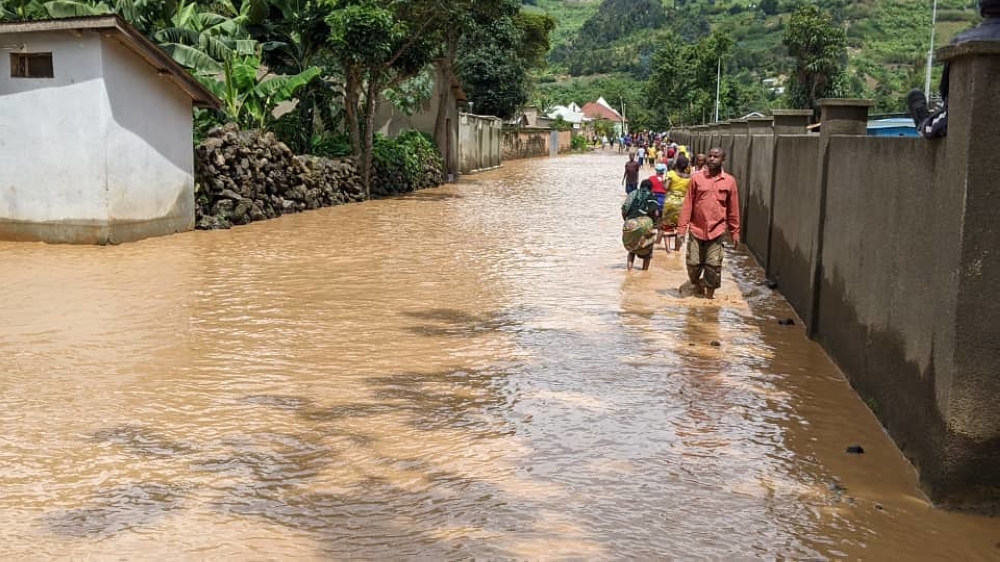 Rubavu residents wade through a flooded residential area in Nyundo sector on May 3, 2023. Rwanda has identified a $7.1 billion funding gap to meet its climate action targets under the Paris Agreement by 2030. File