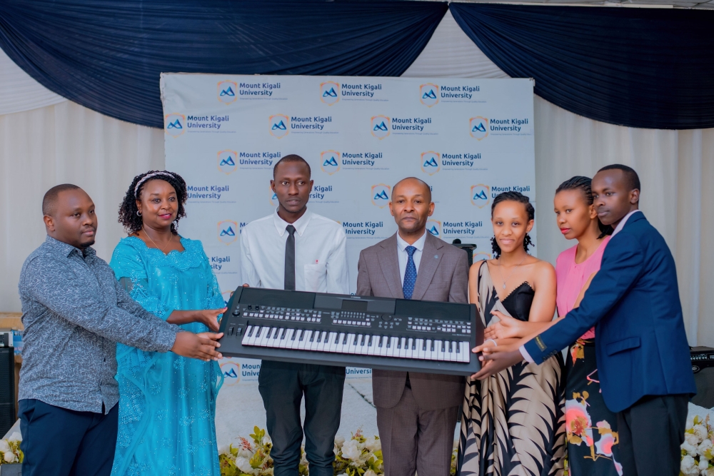 Dr. Jane Nyutu (2nd from left) hands over donated equipment to Dr. Martin Kimemia (4th from left), as  Antony Kamau, Board of Directors Representative (1st from left), Lucie Uwimana , Dean of Students (2nd from right), and students look on.