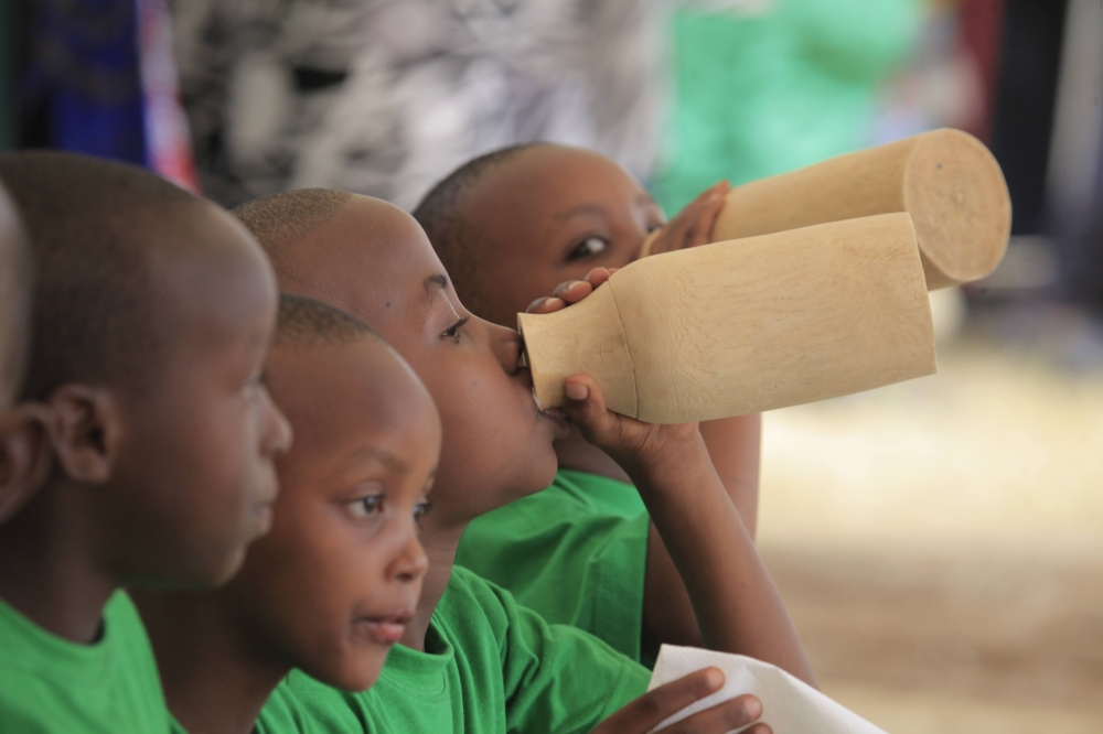 Children drink milk during the celebration of Umuganura in Nyanza District. Sam Ngendahimana 