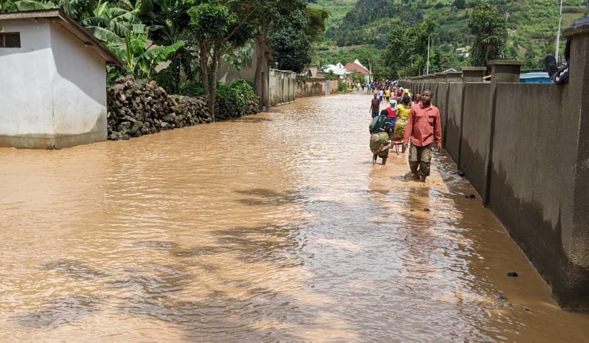 Rubavu residents wade through a flooded residential area in Nyundo sector on May 3, 2023. Rwanda has identified a $7.1 billion funding gap to meet its climate action targets under the Paris Agreement by 2030. File