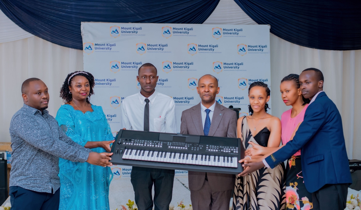 Dr. Jane Nyutu (2nd from left) hands over donated equipment to Dr. Martin Kimemia (4th from left), as  Antony Kamau, Board of Directors Representative (1st from left), Lucie Uwimana , Dean of Students (2nd from right), and students look on.