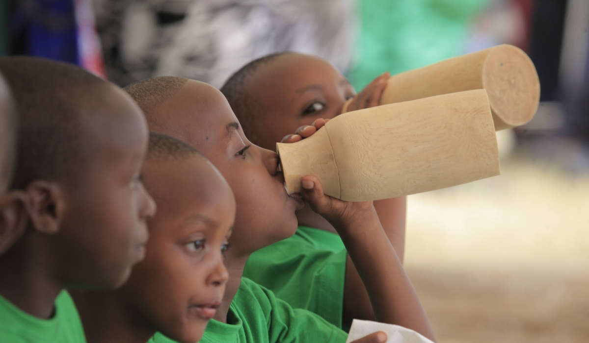 Children drink milk during the celebration of Umuganura in Nyanza District. Sam Ngendahimana 