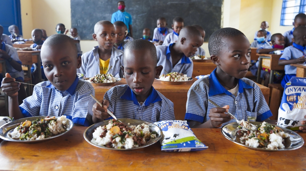 Students have lunch at school through school feeding programme in Kicukiro District. Photo by Craish Bahizi