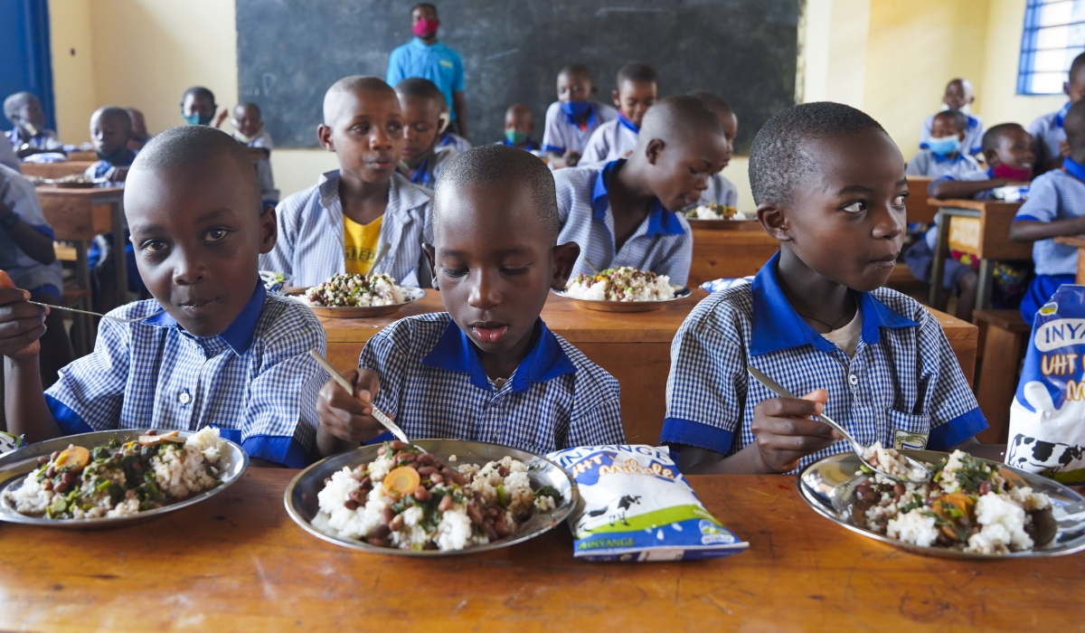 Students have lunch at school through school feeding programme in Kicukiro District. Photo by Craish Bahizi