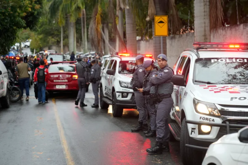 Police stand along the street leading to the gated community where a plane crashed in Sao Paulo state, Brazil, Friday, August 9, 2024. Courtesy