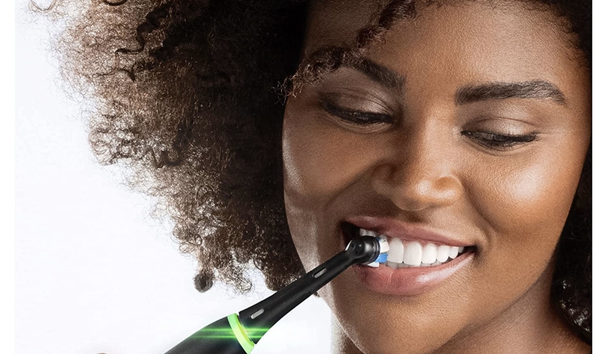 A woman brushing her teeth. Here are tips to enhance your oral hygiene. Internet