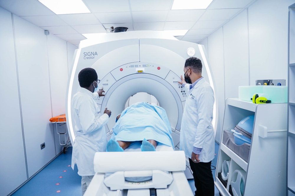 Doctors conduct a screening exam at Legacy Clinic in Kigali. File