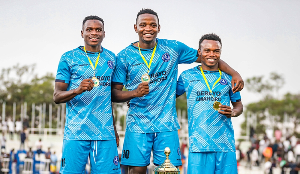 Police FC player  Muhadjiri Hakizimana (C) poses for a photo with teammates after beating APR FC 6-5 penalties to win Super Cup title on Saturday. Craish BAHIZI