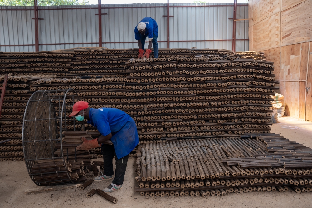 Workers sort brigquettes at OAK Investments that are used in clean cooking. Briquette are used to reduce the number of households that depend on firewood and charcoal for cooking.Courtesy