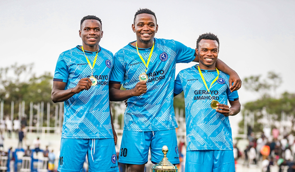 Police FC player  Muhadjiri Hakizimana (C) poses for a photo with teammates after beating APR FC 6-5 penalties to win Super Cup title on Saturday. Craish BAHIZI