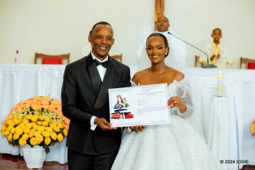 Aurore Kayibanda and businessman Jacques Gatera pose during their wedding ceremony at Marie Auxiliatrice Church on Thursday, August 15. PHOTOS BY IGIHE