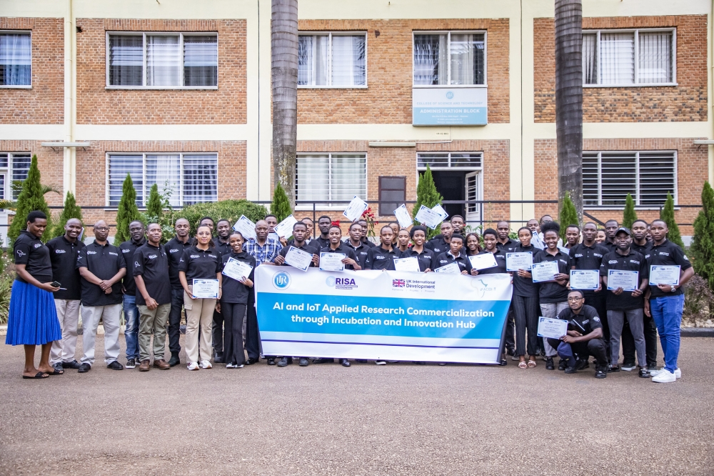 Trainees and officials pose for a group photo after concluting the workshop. Emmanuel Dushimimana