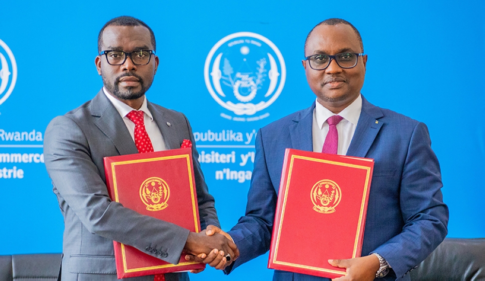 The outgoing Minister of Trade and Industry Jean Chrysostome Ngabitsinze and the newly appointed Minister  Prudence Sebahazi  during the handover ceremony in Kigali on Tuesday, August 20.