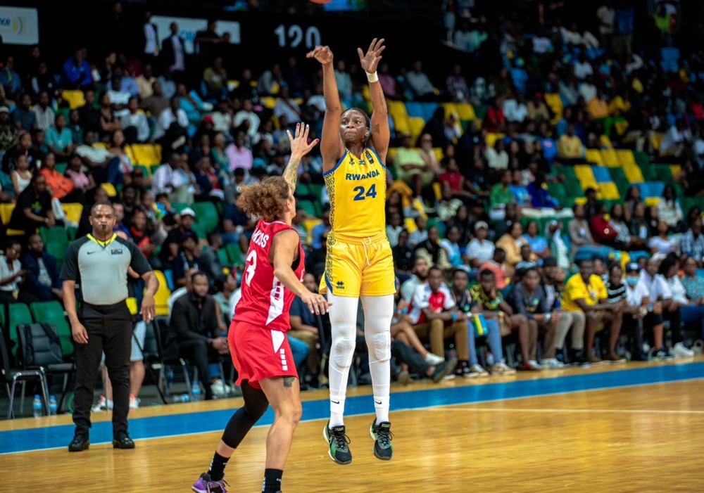 American-born powerforward Keisha Hampton takes a three pointer during Rwanda&#039;s 80-62 victory over Lebanon in a Group D game on Monday, August 20 at BK Arena- Photo by Dan Gatsinzi