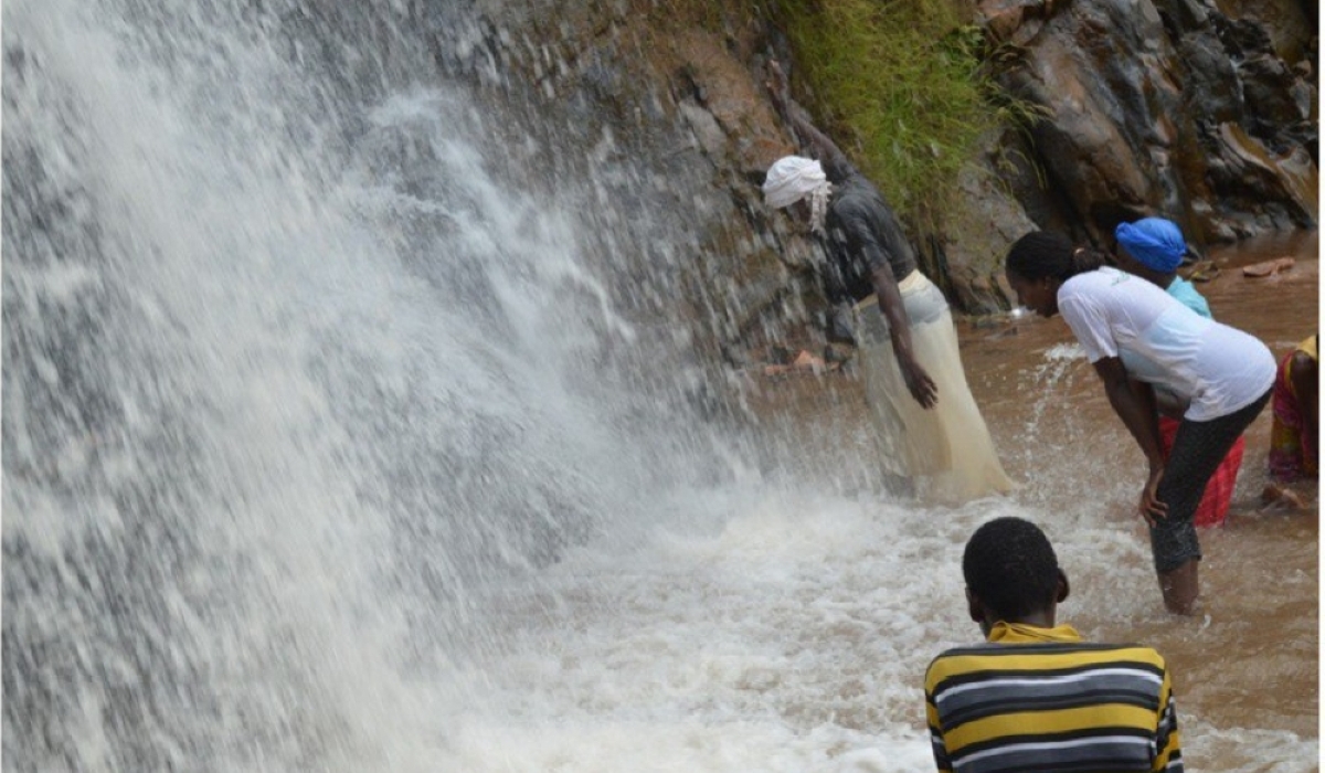 Christians seek healing at a waterfall in Nyungwe National Park. Rwanda has closed over 10000 churches that are not meeting minimum standards required by Rwanda Governance Board. Courtesy