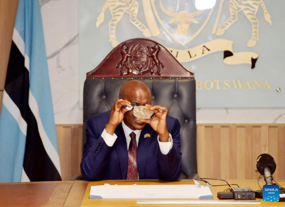 Botswanan President Mokgweetsi Masisi inspects the 2,492-carat diamond discovered in the Karowe Diamond Mine in north-central Botswana, in Gaborone, Botswana, on Aug. 22, 2024. (Photo by Tshekiso Tebalo/Xinhua)