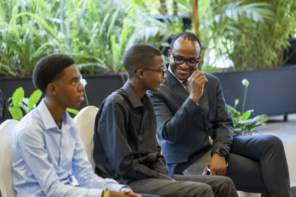 Minister of Education Gaspard Twagirayezu interacts with Denys Prince Tuyisenge who won a gold medal in the Pan African Mathematics Olympiad, at Village Urugwiro . Photos by Olivier Mugwiza