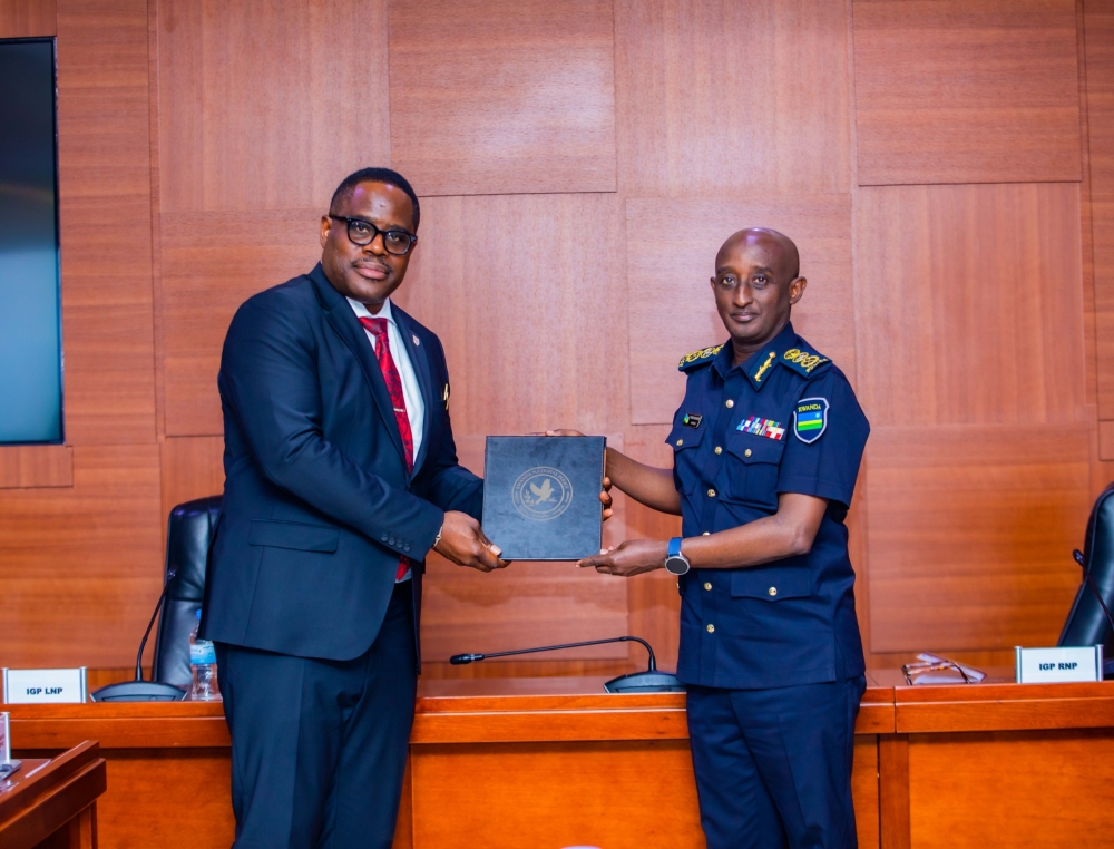 IGP  Felix Namuhoranye and his Liberian counterpart, Gregory Coleman during a meeting in Kigali , on Monday, August 26