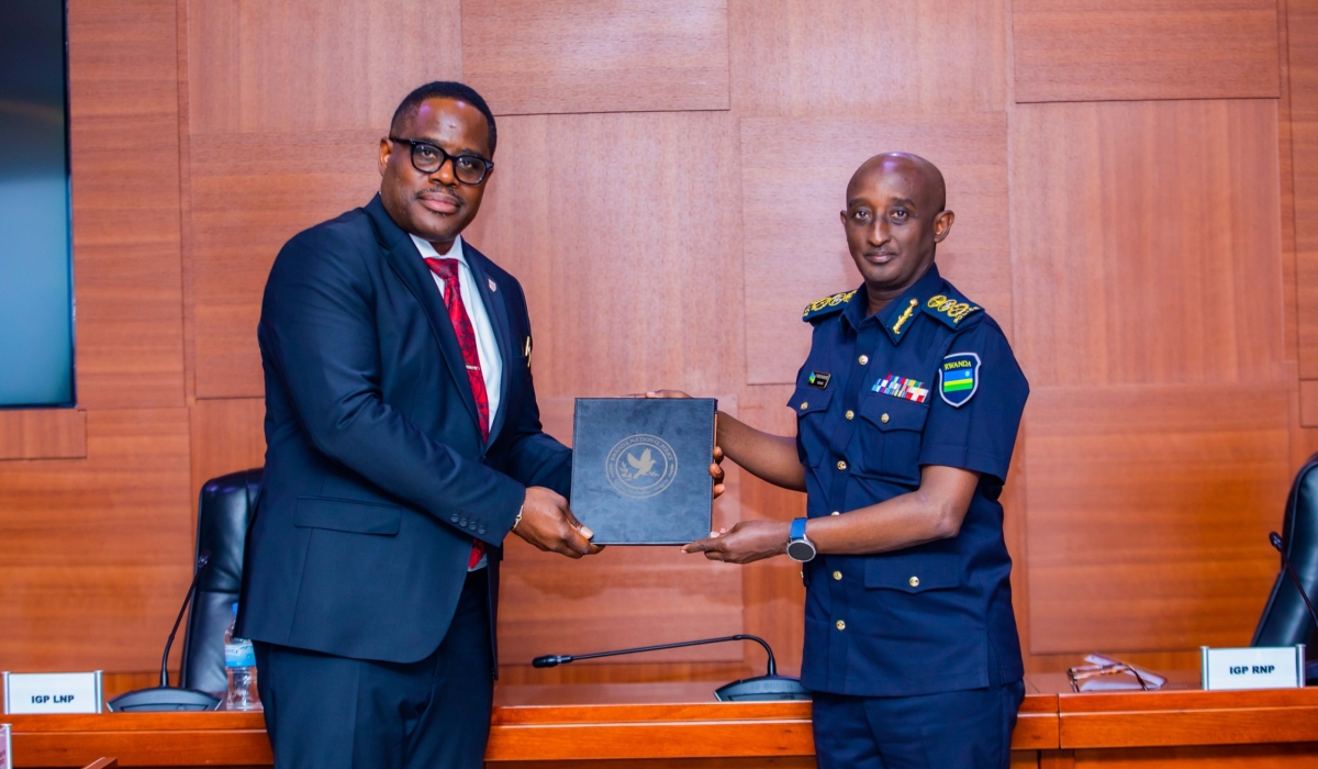 IGP  Felix Namuhoranye and his Liberian counterpart, Gregory Coleman during a meeting in Kigali , on Monday, August 26