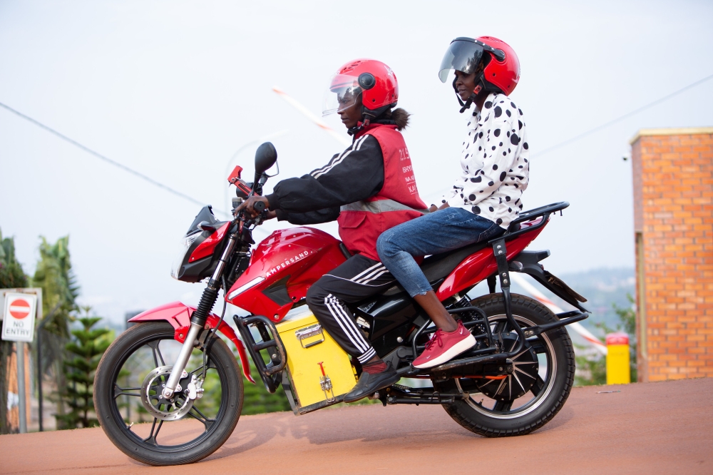 Taxi-moto rider with a client in Kigali. Ampersand has secured new equity investment from AHL Venture Capital and Everstrong Capital. File