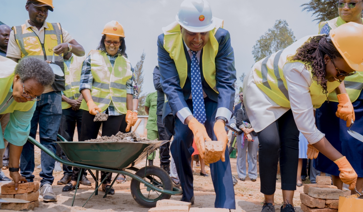 Imbuto Foundation Director General, Elodie Shamie (right), Mount Kigali University founder and chairman, Prof. Simon Gicharu, and staff from Imbuto Foundation and Mount Kigali University prepare to lay bricks during the groundbreaking event.