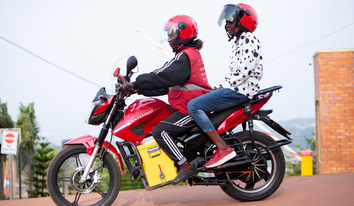 Taxi-moto rider with a client in Kigali. Ampersand has secured new equity investment from AHL Venture Capital and Everstrong Capital. File