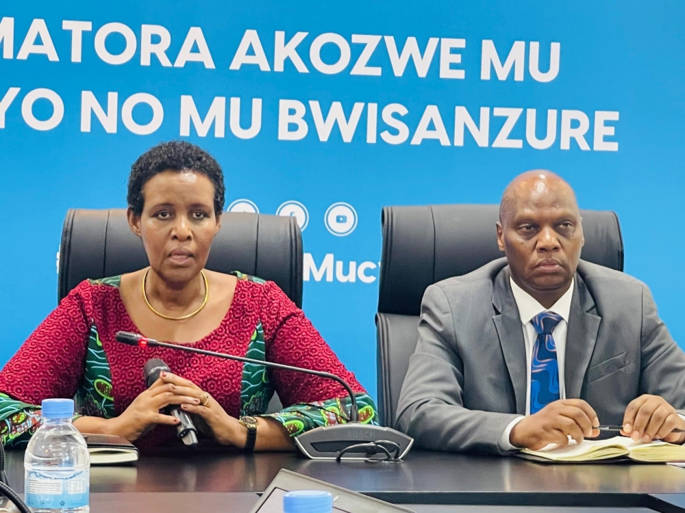 NEC Chairperson Oda Gasinzigwa speaks as Executive Secretary Charles Munyaneza looks on during a press conference in Kigali on Friday, August 30. 