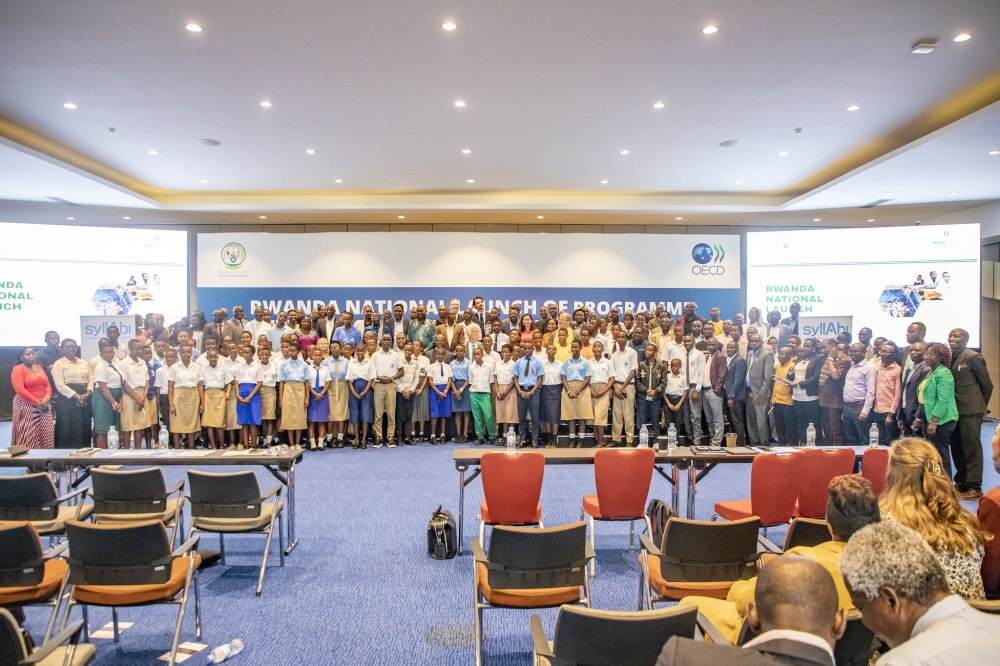 Officials and students pose for a group photo after the launch of Rwanda&#039;s participation in the Programme for International Student Assessment in Kigali, on Friday, August 30. Photos by Emmanuel Dushimimana.